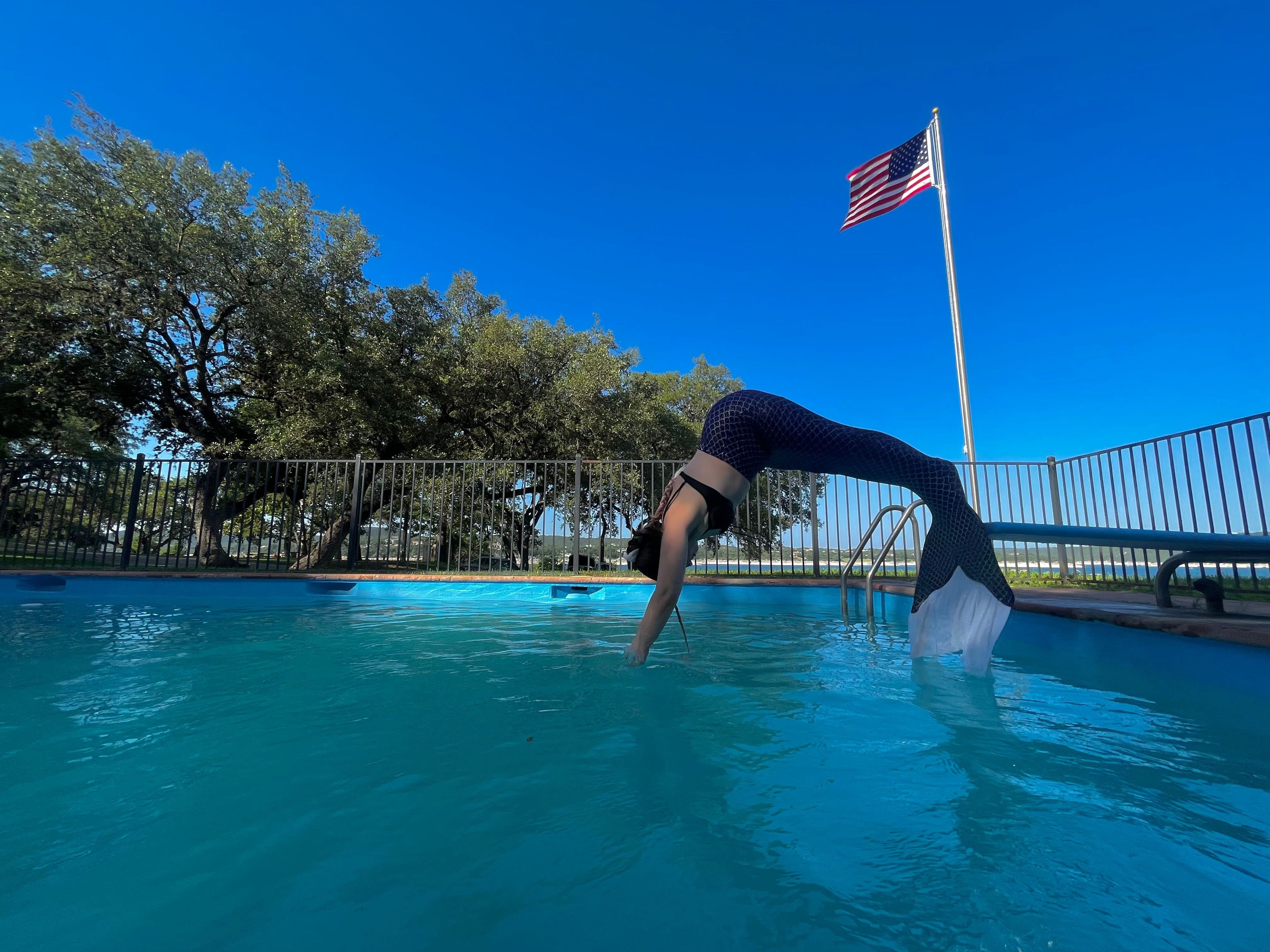 Mermaid dives into a pool on Lake Travis