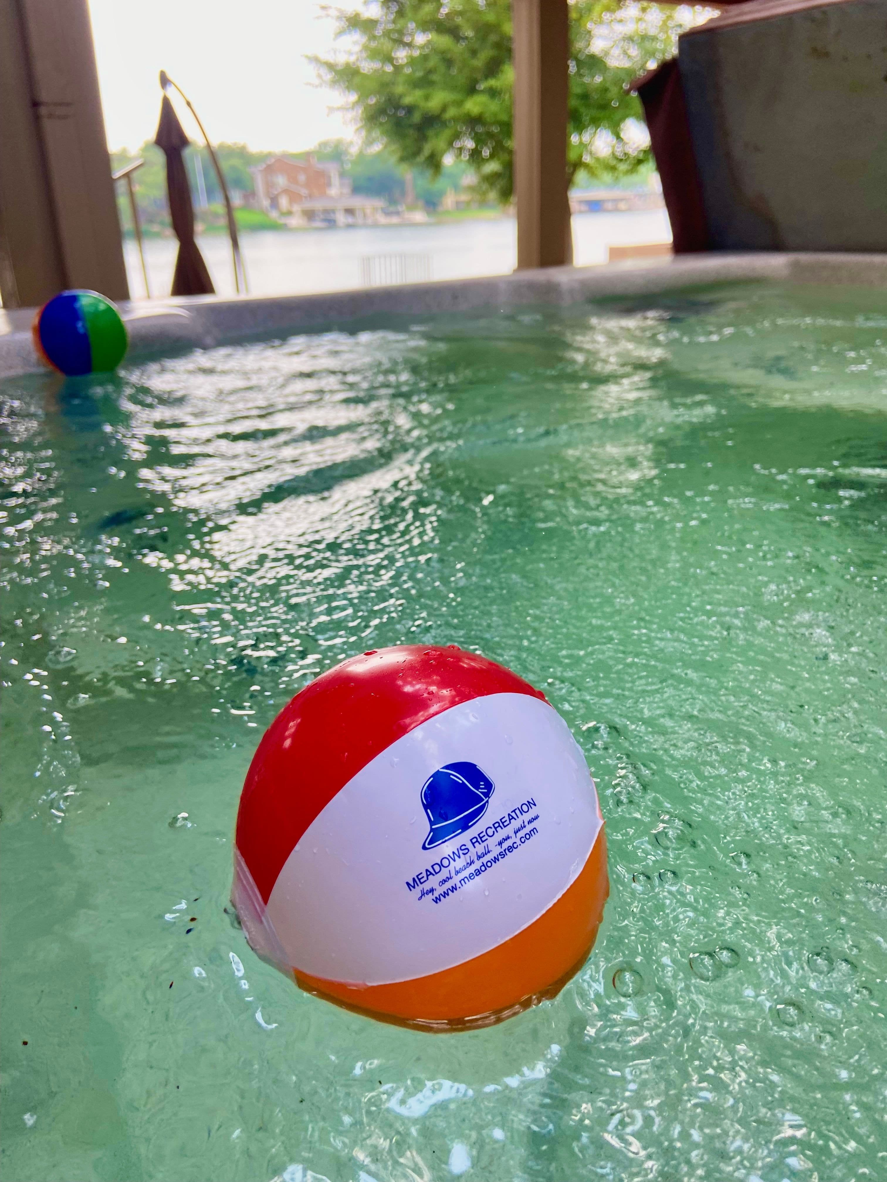 Mini Meadows Recreation beach balls in classic color scheme floating in hot tub